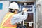 Chinese electrician working at power line box