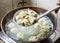 Chinese Family Cooking Boiled Dumplings in Wok