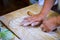 Chinese Family Make Dumpling Skins on Wooden Board