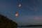 Chinese flying lanterns, flying over the lake in the dark