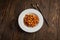 Chinese food, kung pao chicken in white plate with chopsticks on wooden table, top view and copy space