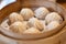 Chinese food, steamed hot Xiaolongbao in bamboo steaming basket.