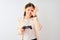 Chinese gamer woman playing video game using headphones over isolated white background with happy face smiling doing ok sign with
