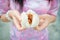 Chinese girl in cheongsam is tearing steamed stuff bun. Steamed