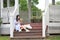 Chinese Girl reading book. Blonde beautiful young woman with book sit on the Pavilion steps.