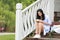 Chinese Girl reading book. Blonde beautiful young woman with book sit on the Pavilion steps.