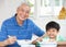 Chinese Grandfather And Grandson Eating Meal