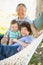 Chinese Grandparents In Hammock with Mixed Race Grandchild