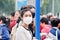 Chinese gril with breath protection against smog, Beijing, China