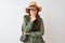 Chinese hiker woman wearing canteen hat glasses backpack over isolated white background looking confident at the camera with smile