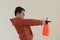 Chinese kid holding sprinkling can to spray disinfectant