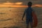 Chinese kid with Swimming ring on beach sunset time