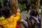 Chinese kids touching the tree for the wish of luck, in the Huangguoshu Waterfall National Park in Guizhou Province in China, in