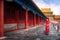 Chinese lady walk in red cheongsam dress in ancient Chinese forbidden palace