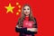 Chinese language school. Beautiful smiling woman with flag