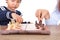 Chinese little girl is learning to play chess under the guidance of teacher