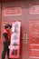 Chinese man post new year`s scrolls , Spring festival couplets and Mars at red door in China