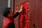 Chinese man post new year`s scrolls , Spring festival couplets and Mars at red door in China