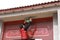 Chinese man post new year`s scrolls , Spring festival couplets and Mars at red door in China