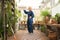 Chinese martial arts tai chi. Woman practicing Taijiquan discipline in a greenhouse with flowers