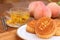 Chinese Moon Cakes with Chrysanthemum Tea and Peaches in narrow focus