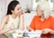 Chinese Mother And Adult Daughter Eating Meal