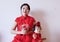Chinese mother and child in red cheongsam do good luck pose