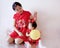 Chinese mother and child in red cheongsam have fun
