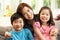 Chinese Mother And Children Sitting On Sofa