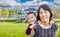 Chinese Mother and Mixed Race Child In The Front Yard of Custom