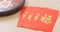 Chinese new year assorted snack box with red pocket, red poacker with a chinese word meaning luck