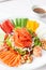 Chinese new year auspicious food Yu Sheng eating on celebrations ingredients with peanut, salmon, nut, red ginger, sliced carrot