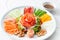 Chinese new year auspicious food Yu Sheng eating on celebrations ingredients with peanut, salmon, nut, red ginger, sliced carrot