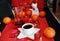 Chinese new year coffee still life. Black coffee in white cup. Traditional fabric pattern. White rat, tangerines