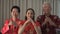 Chinese New Year family salute etiquette palm and fist gesture bounding