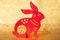 Chinese New Year Rabbit mascot paper cut on golden background the Chinese means fortune no logo no trademark