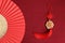 Chinese New Year, red paper fans with lucky decorative golden coins with Chinese blessing words means happiness, richness and good