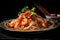 Chinese noodles with shrimp, vegetables, and sauce on plate