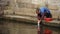 Chinese old woman wash cloths under bridge,china water town life.