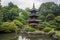 chinese pagoda surrounded by rush of water, with view of lush gardens