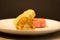 Chinese pastry with golden yolk thread inside on white plate