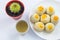 Chinese Pastry Mung Bean or Mooncake with Egg Yolk on dish and green tea cup