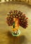 Chinese peacock bird statuette on golden background