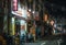 Chinese people have dinner in street cafe at night in Chinatown