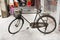 Chinese people stopping classic retro vintage old bicycle with basket at front of house in old town at Chaozhou or Teochew