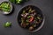 Chinese pickled ear tree black muer mushrooms in bowl on black background.