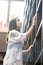 Chinese Portrait of young beautiful woman reaching for a library book In Bookstore