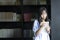 Chinese Portrait of young beautiful woman reads Book In Bookstore