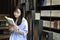 Chinese Portrait of young beautiful woman reads Book In Bookstore