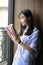 Chinese Portrait of young beautiful woman reads Book In Bookstore